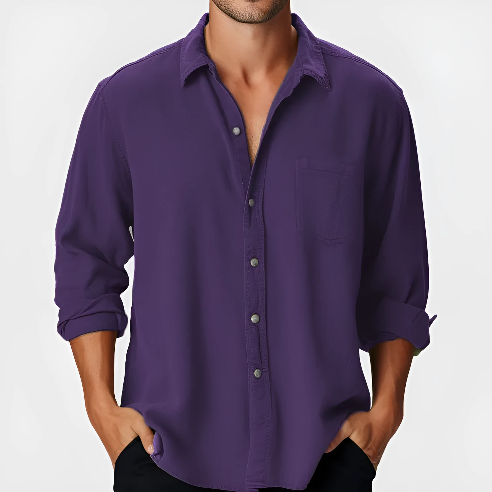 Man wearing a loose-fit blue casual shirt with a stand collar and long sleeves on a beach.