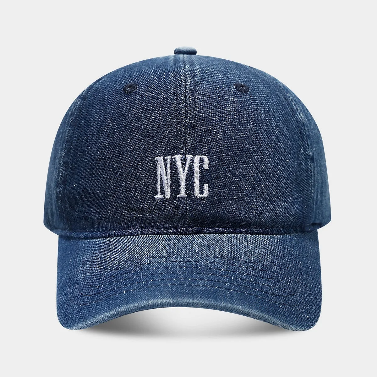 Adjustable denim peaked cap with embroidered lettering in light blue, dark blue, or black