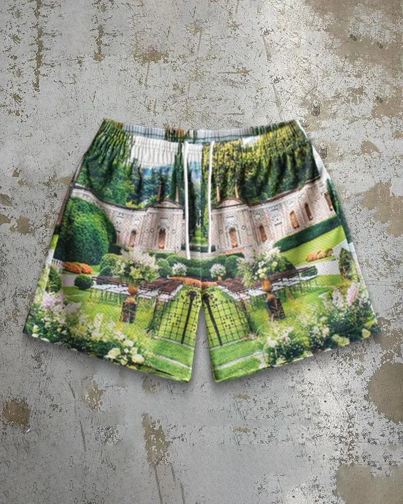 Man wearing loose blue digital print beach shorts made from quick-dry milk silk polyester fabric.