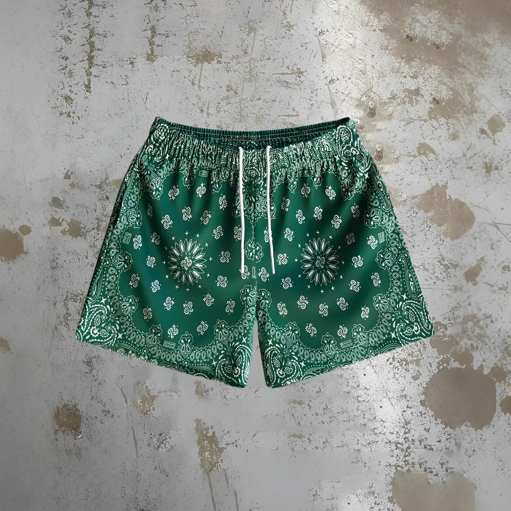Man wearing loose blue digital print beach shorts made from quick-dry milk silk polyester fabric.