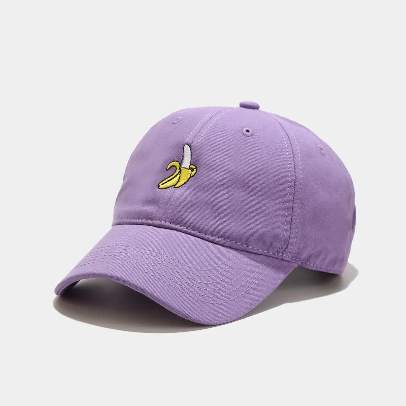 Curved peak baseball cap with embroidered banana fruit design in light purple colour on a white background.