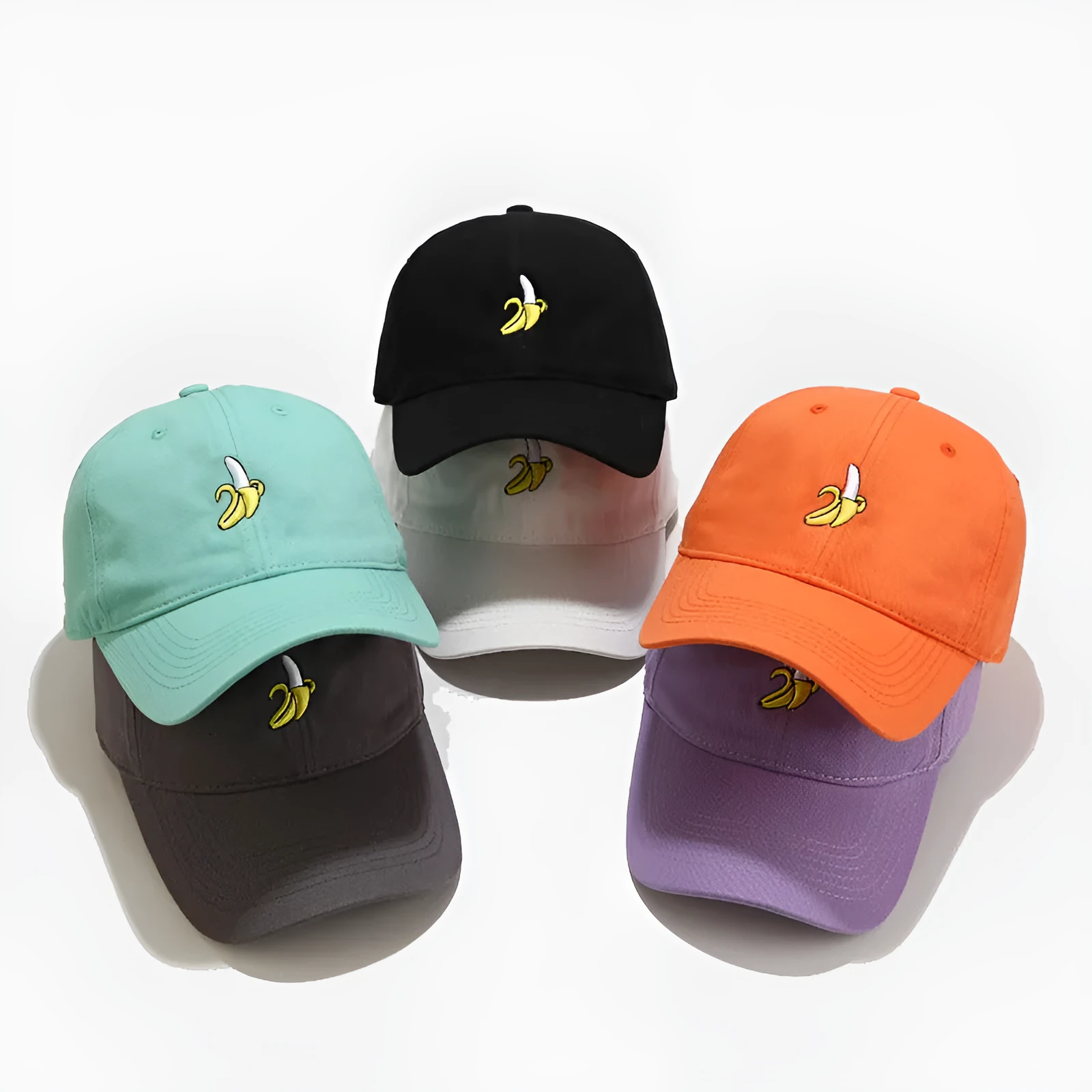 Curved peak baseball cap with embroidered banana fruit design in light purple colour on a white background.