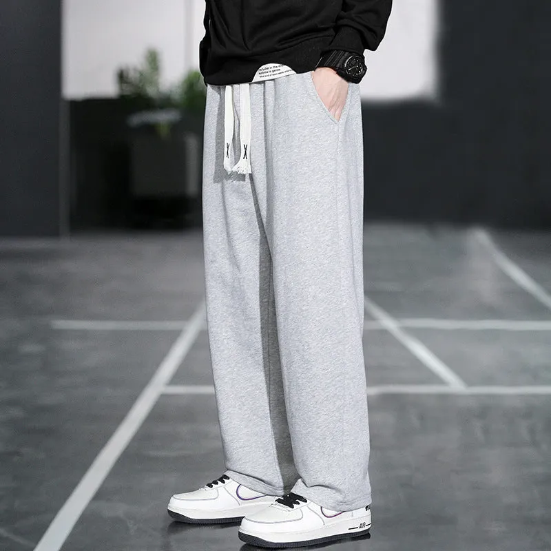 Men's grey casual trousers with multiple pockets showing high waist design and full length