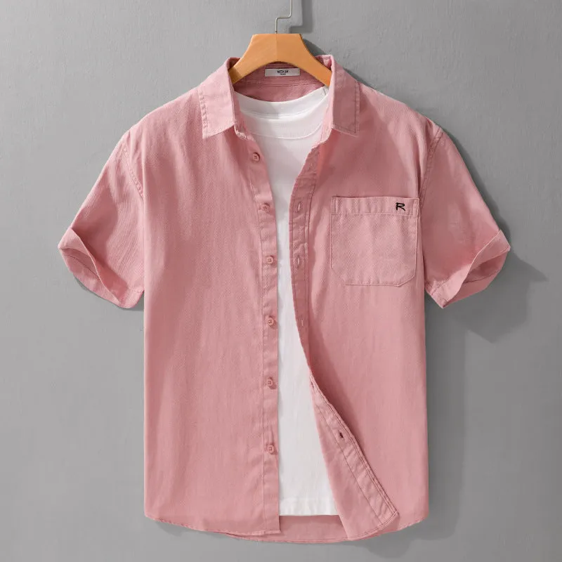 Men's light blue loose fit short-sleeved cotton shirt with a cardigan style front, laid flat.
