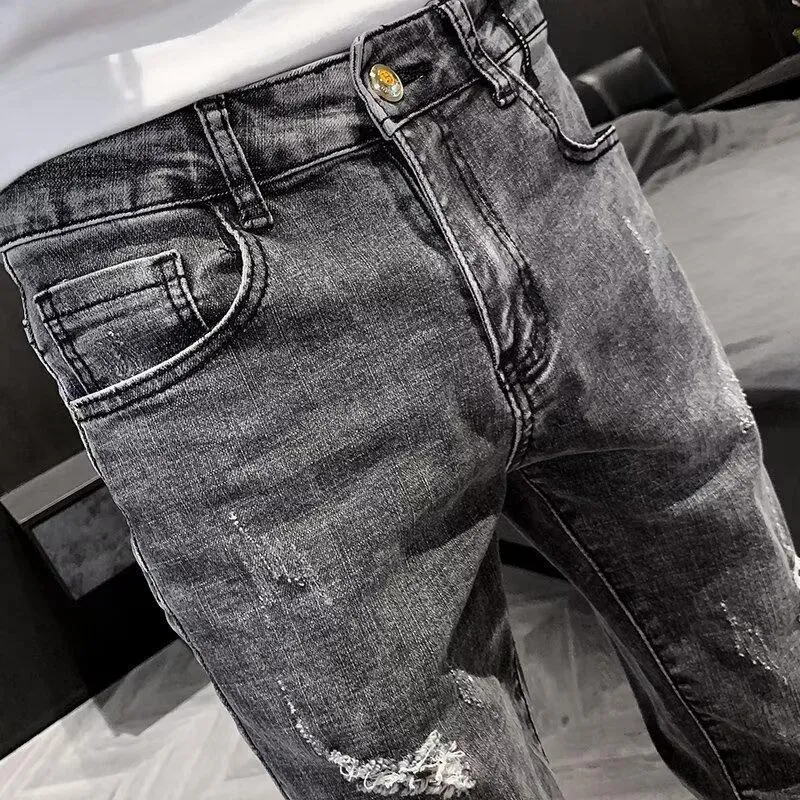 Men's high waist blue jeans with a five-pocket design and button fly on a mannequin.