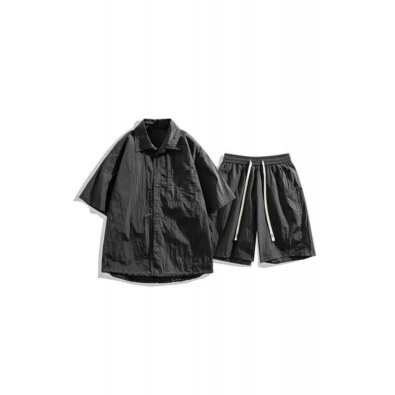 Man wearing a loose dark grey hemp-blend casual shirt with matching shorts from a two-piece set.