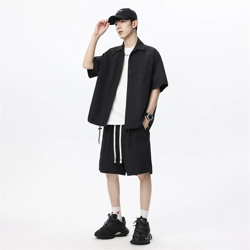 Man wearing a loose dark grey hemp-blend casual shirt with matching shorts from a two-piece set.