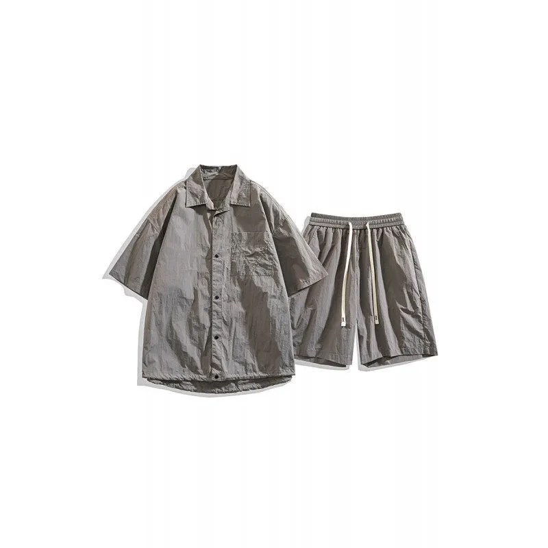 Man wearing a loose dark grey hemp-blend casual shirt with matching shorts from a two-piece set.