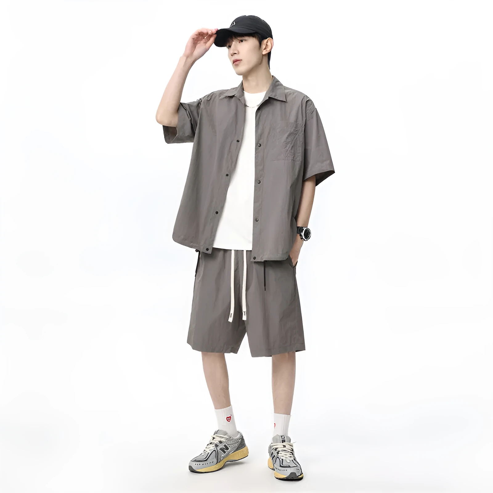 Man wearing a loose dark grey hemp-blend casual shirt with matching shorts from a two-piece set.