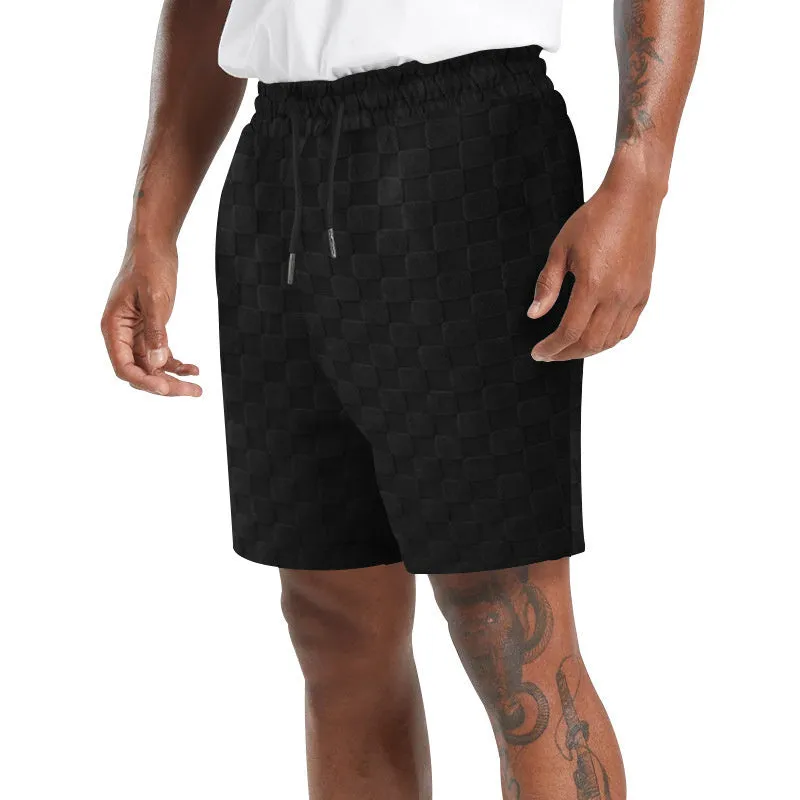 Men's black and white checkerboard plaid loose sports shorts with an elastic waistband.