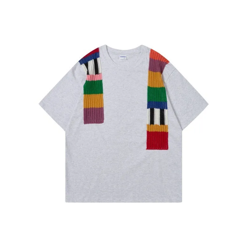 Men's loose grey cotton T-shirt with black and white patchwork letter design on chest.