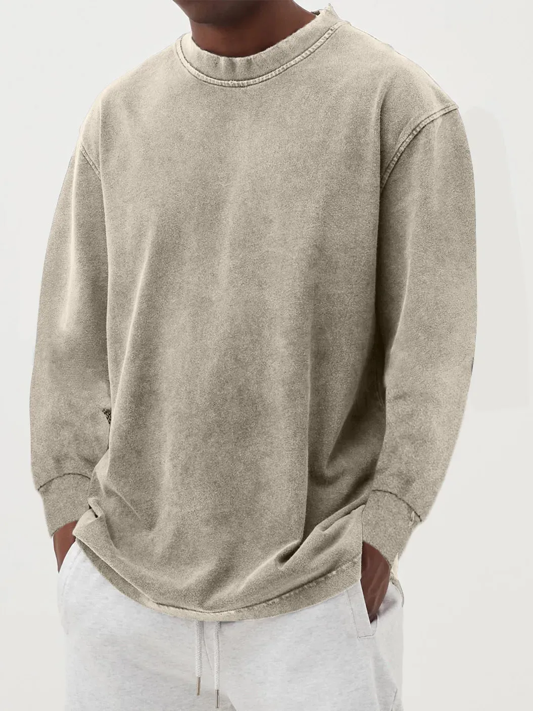 Man wearing a slim fit long sleeve t-shirt in a solid colour, with options in sky blue, green, gray, black, and camel.