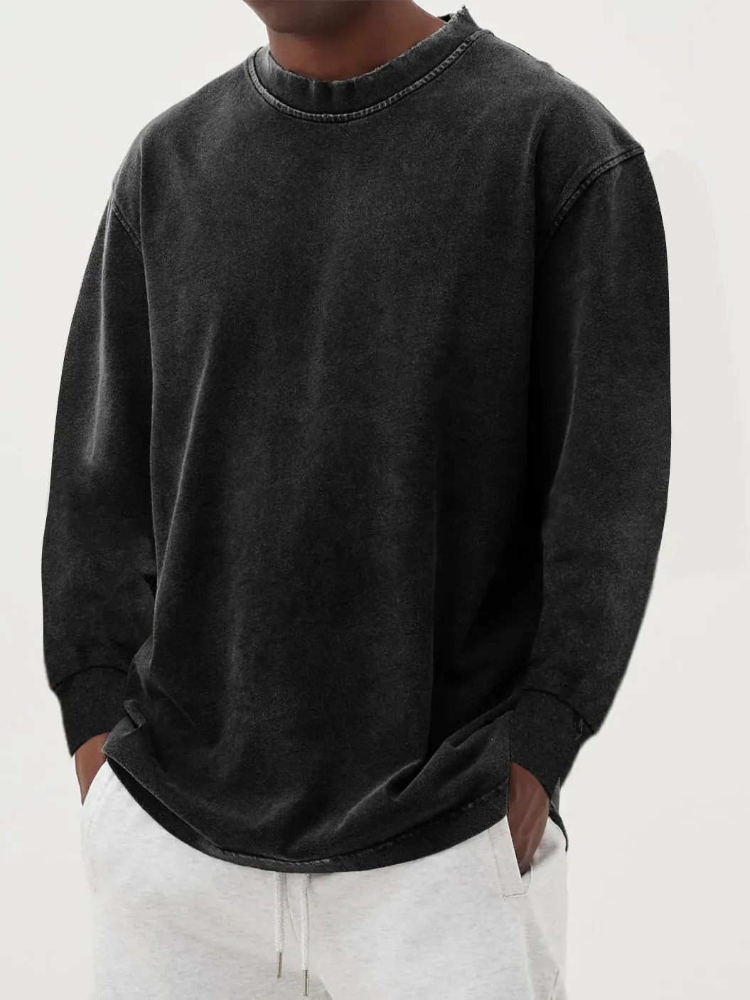 Man wearing a slim fit long sleeve t-shirt in a solid colour, with options in sky blue, green, gray, black, and camel.