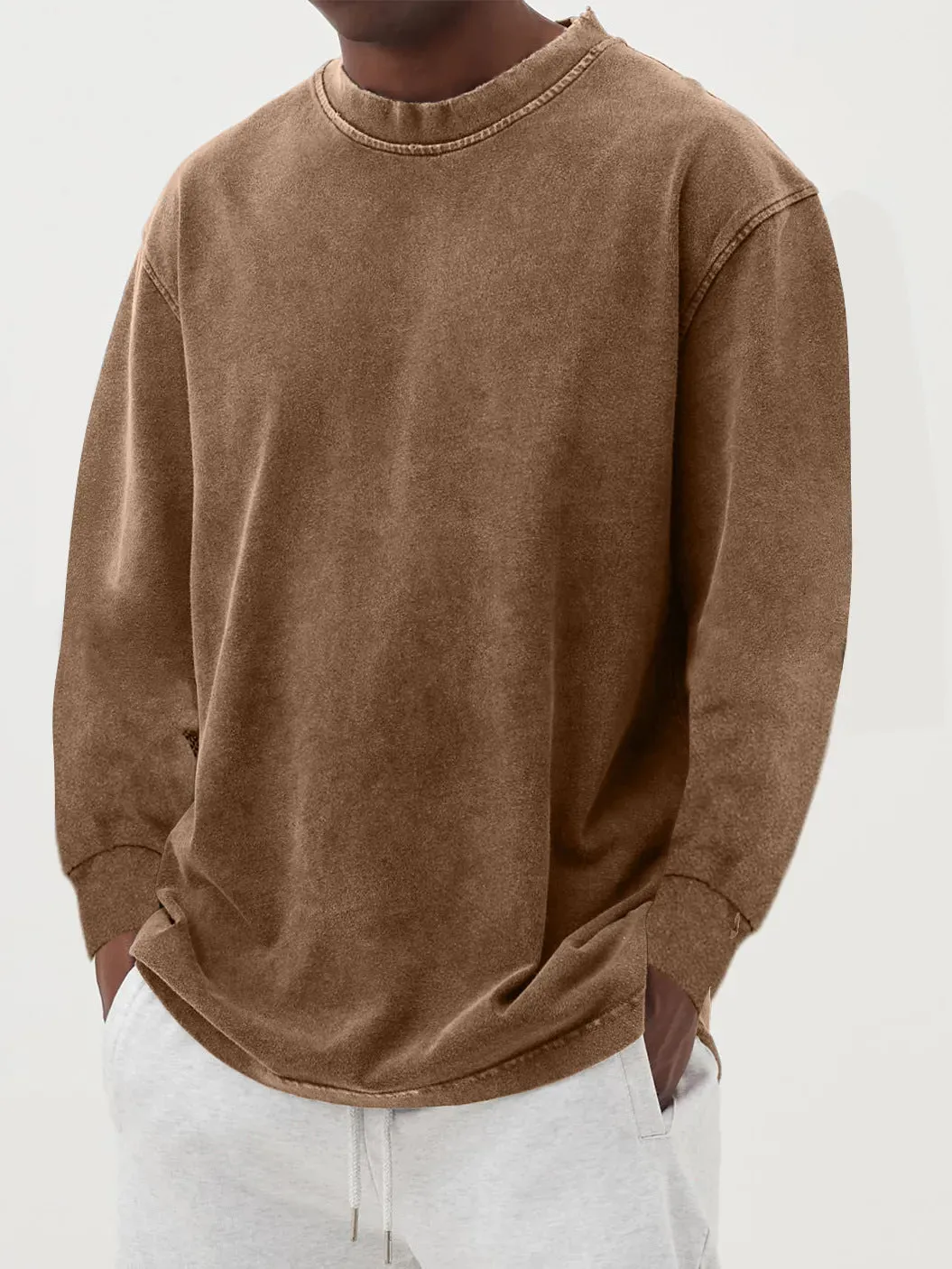 Man wearing a slim fit long sleeve t-shirt in a solid colour, with options in sky blue, green, gray, black, and camel.