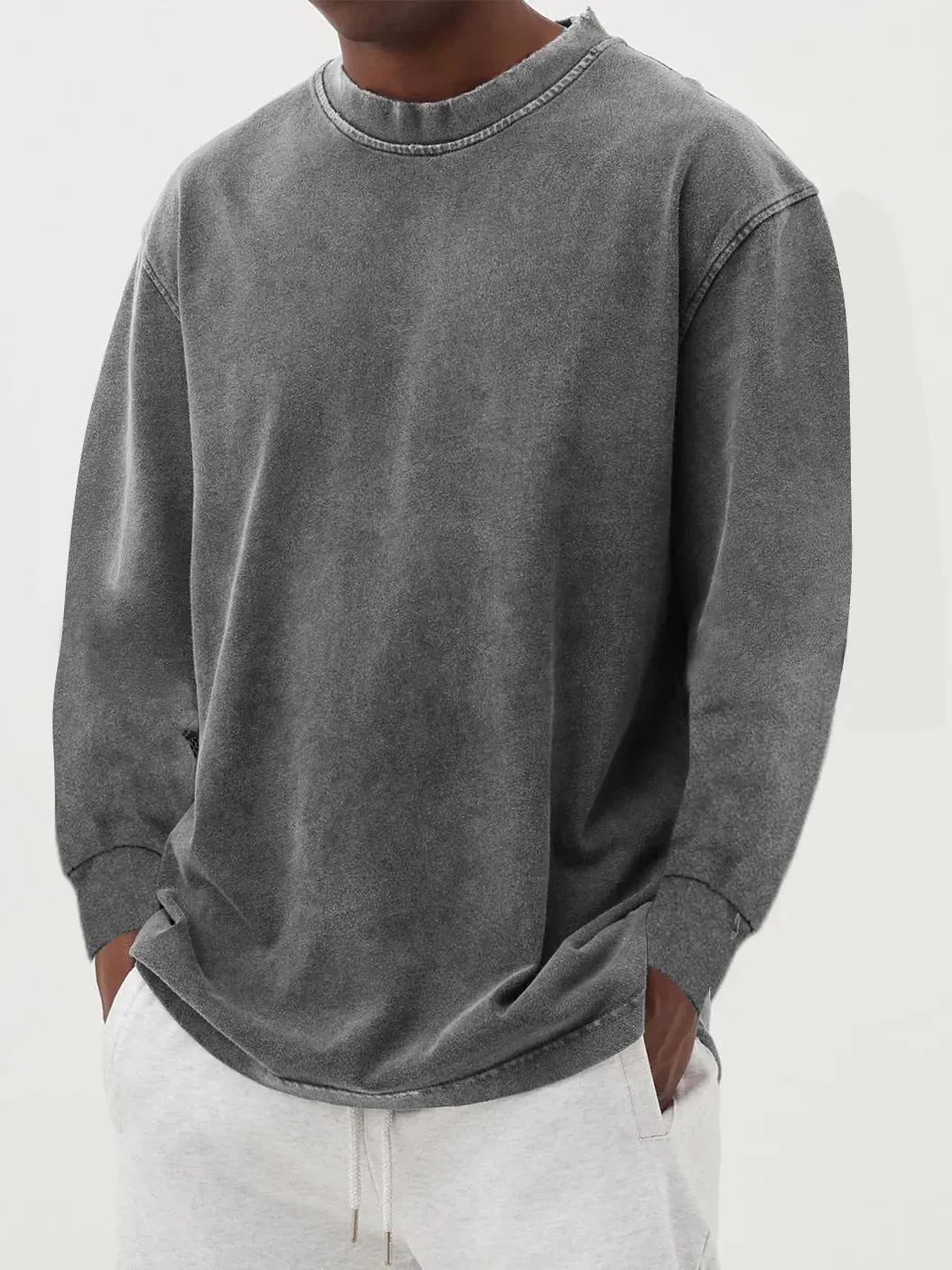 Man wearing a slim fit long sleeve t-shirt in a solid colour, with options in sky blue, green, gray, black, and camel.