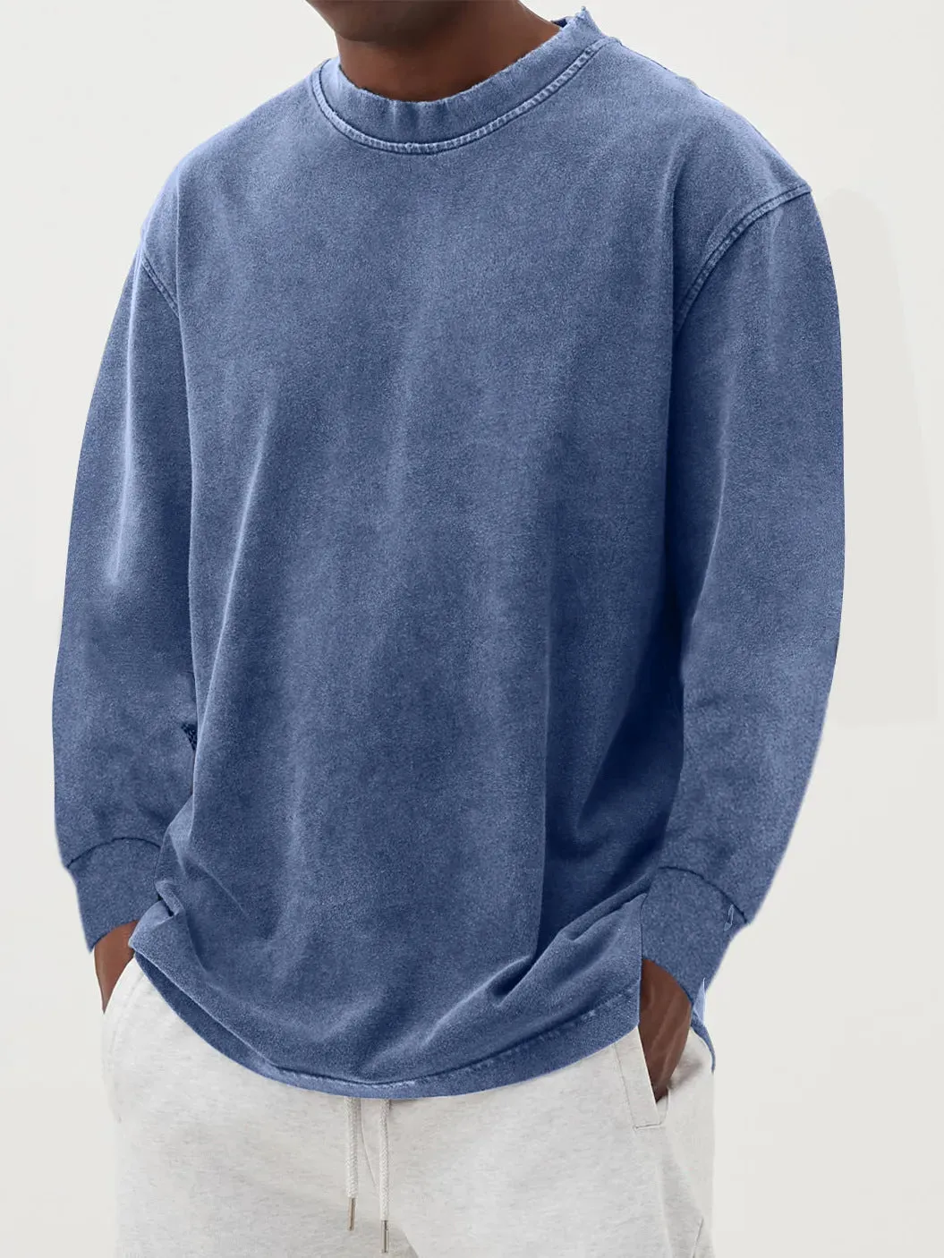 Man wearing a slim fit long sleeve t-shirt in a solid colour, with options in sky blue, green, gray, black, and camel.