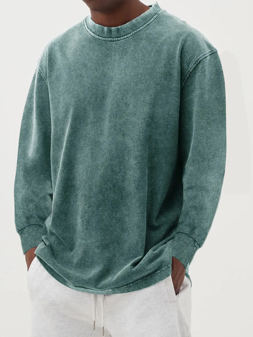 Man wearing a slim fit long sleeve t-shirt in a solid colour, with options in sky blue, green, gray, black, and camel.