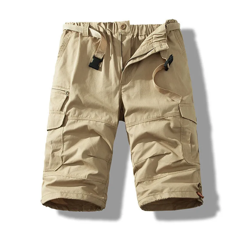 Men's cotton cropped overalls in army green, shown in a casual summer setting.