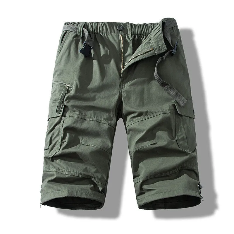 Men's cotton cropped overalls in army green, shown in a casual summer setting.