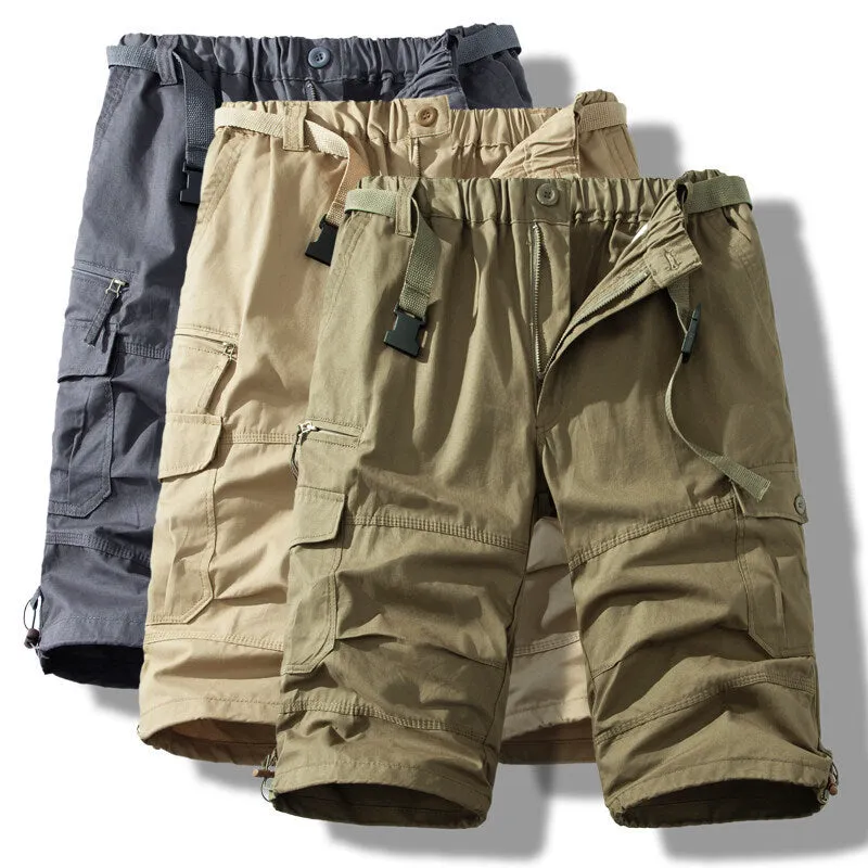Men's cotton cropped overalls in army green, shown in a casual summer setting.