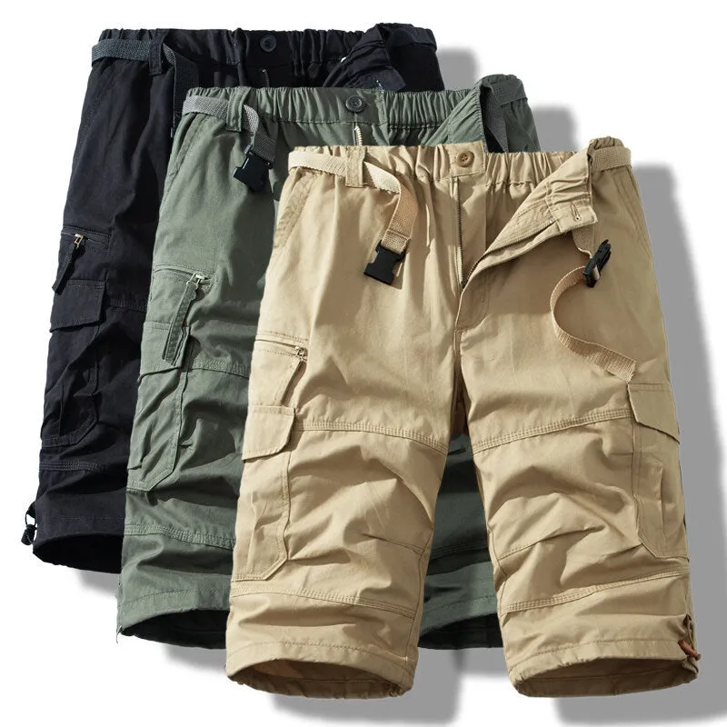 Men's cotton cropped overalls in army green, shown in a casual summer setting.