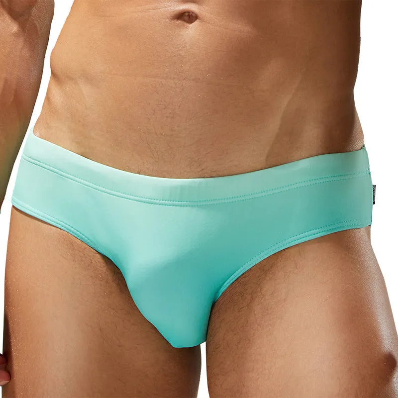 Men's solid colour polyester swim trunks in briefs style for swimming.