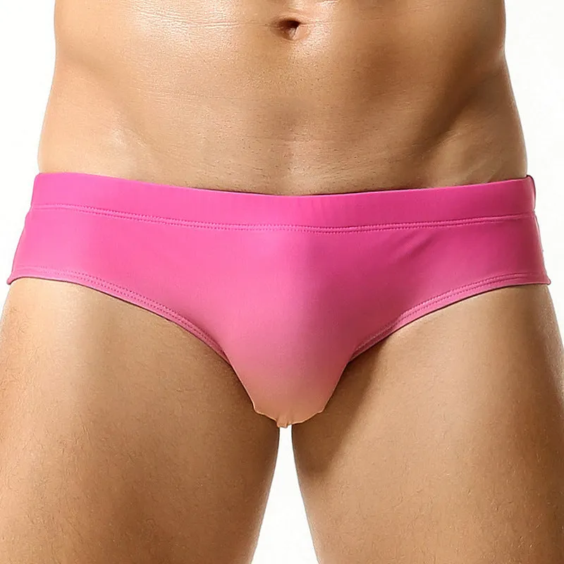 Men's solid colour polyester swim trunks in briefs style for swimming.