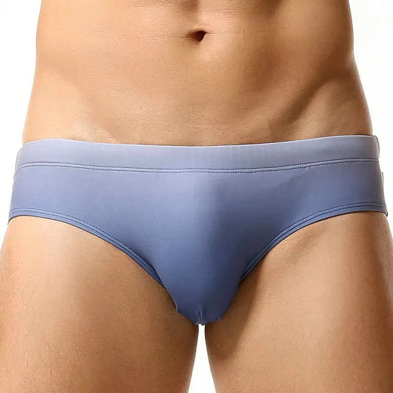Men's solid colour polyester swim trunks in briefs style for swimming.