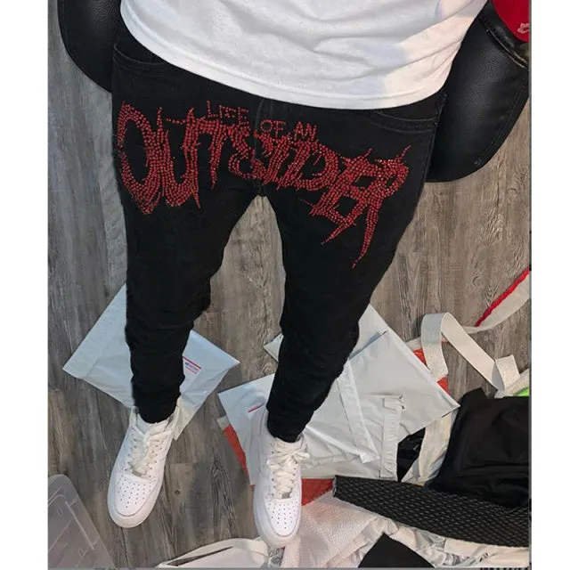 Men's black fashion ripped jeans with slim fit and distressed detailing, shown from front