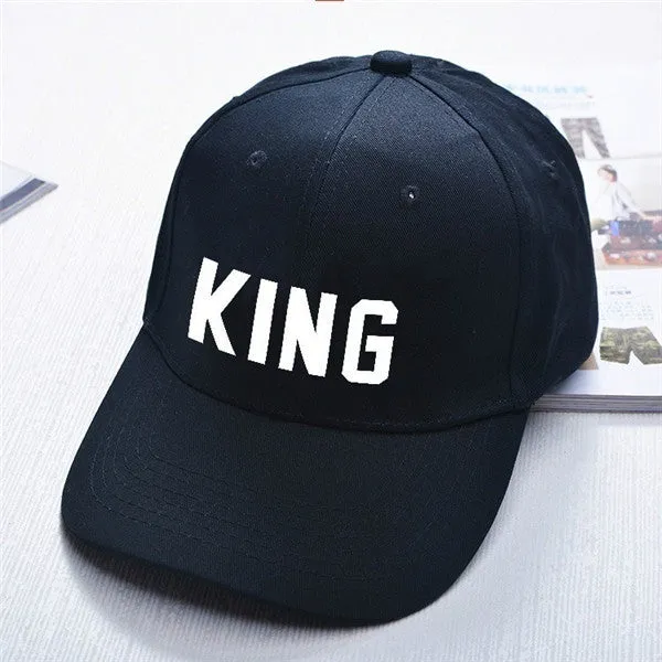 Black printed baseball cap with King design on front, adjustable back strap, on white background