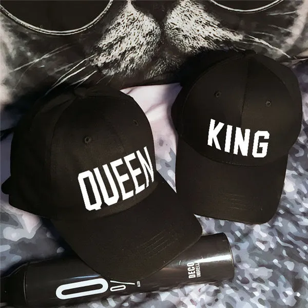 Black printed baseball cap with King design on front, adjustable back strap, on white background