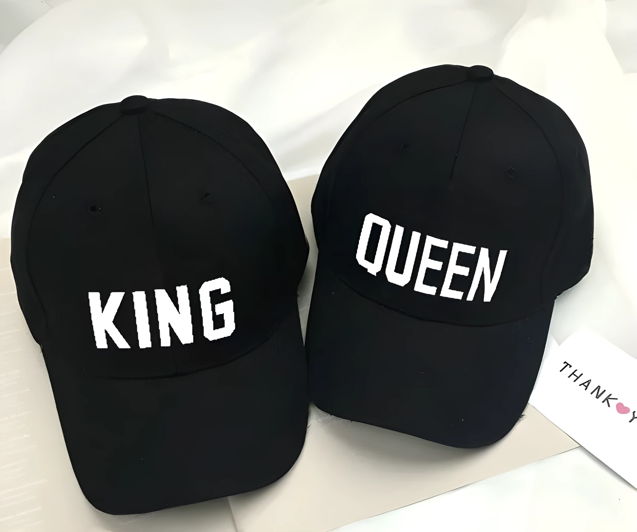 Black printed baseball cap with King design on front, adjustable back strap, on white background