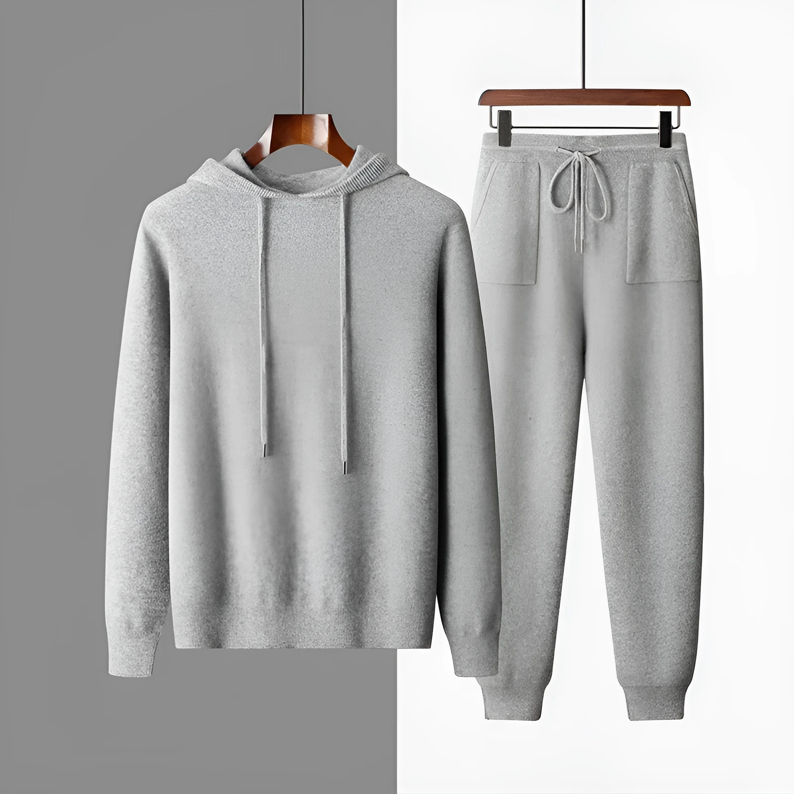 Men's light grey cashmere hooded sweatshirt and matching trousers laid flat.