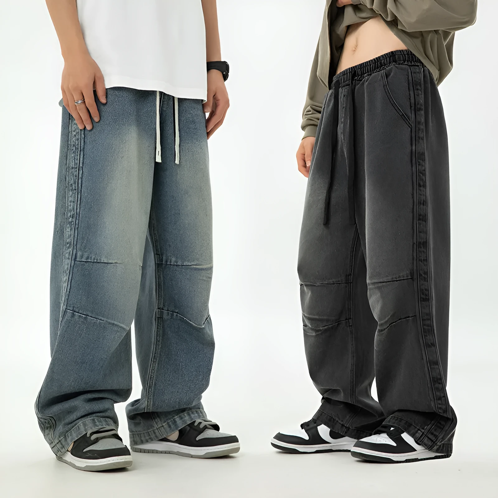Pair of black pleated Japanese drawstring trousers lying flat showing loose-leg silhouette and drawstring waist