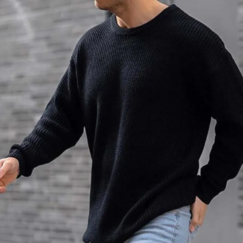 Men's solid colour round neck long sleeve acrylic sweater in black, folded flat on a white background