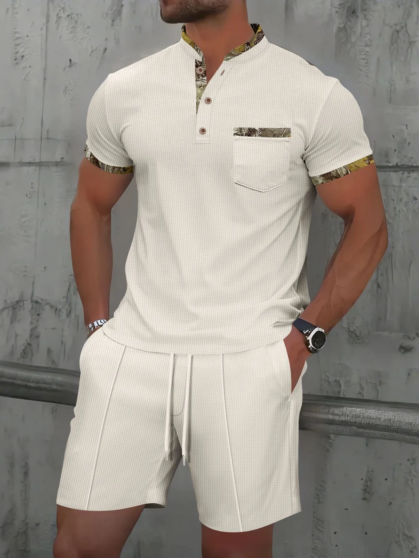 Man wearing a grey waffle knit zip-up polo collar top and matching shorts from a two-piece summer suit.