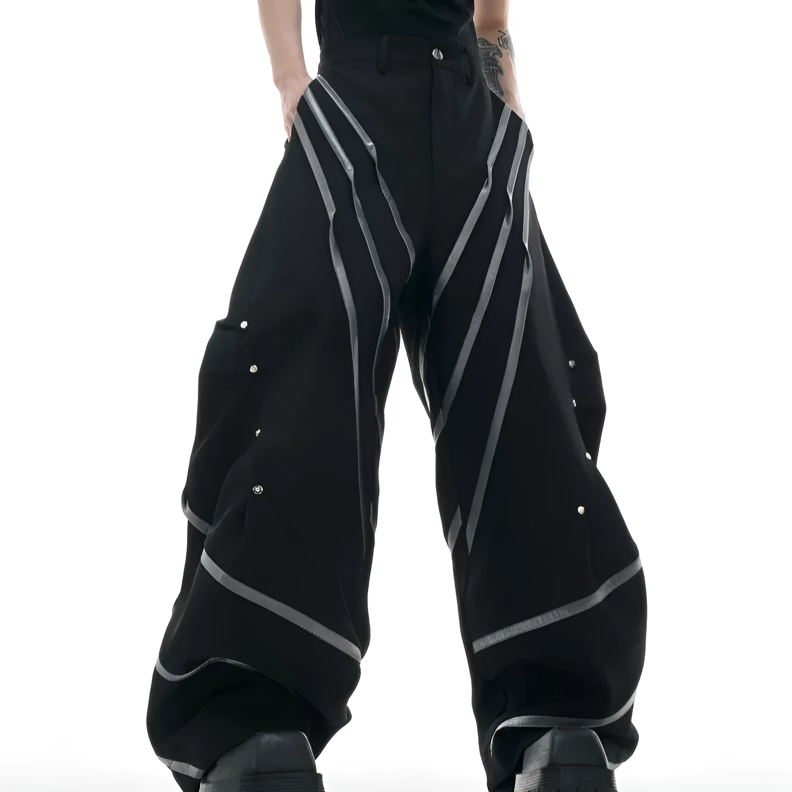 Men's black trousers with metal rivet stripes and pleated detail on the leg.