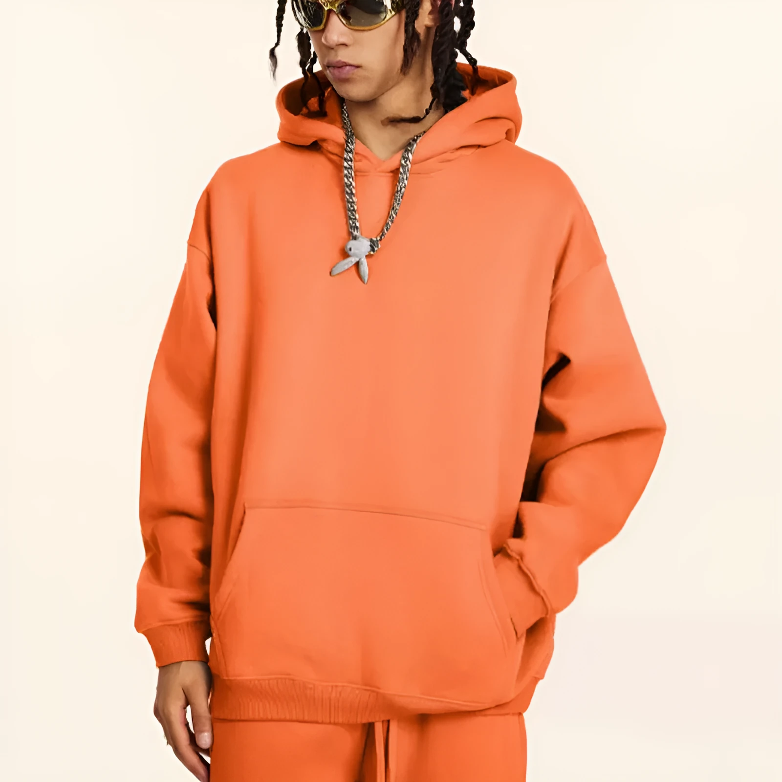 A loose grey men's cotton hooded sweater with drop-shoulder sleeves on a hanger.