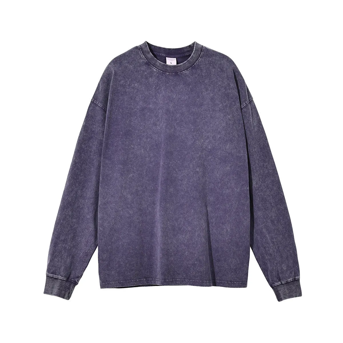 Man wearing a loose-fit batik print long sleeve cotton pullover top in a vintage washed colour.