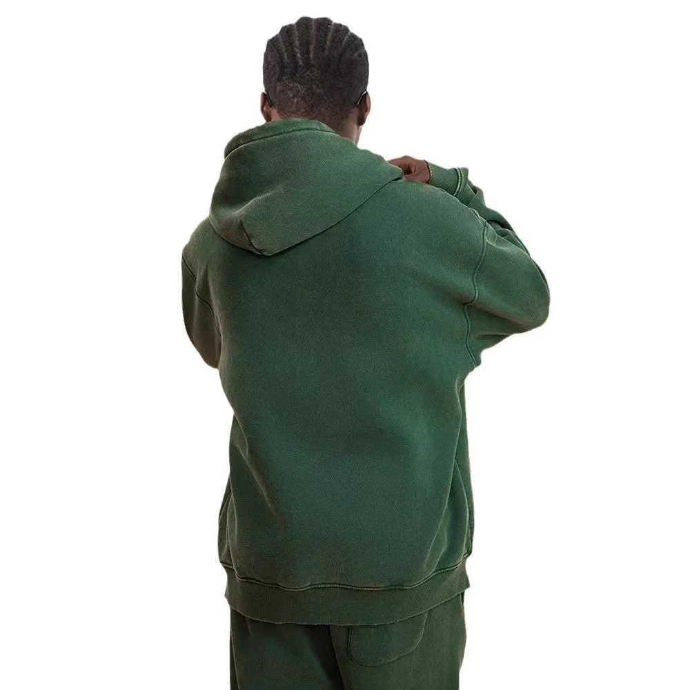 Man wearing a washed black cotton fleece-lined hooded cardigan with a double zipper front.