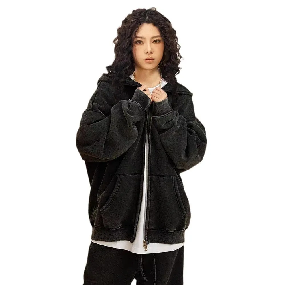 Man wearing a washed black cotton fleece-lined hooded cardigan with a double zipper front.