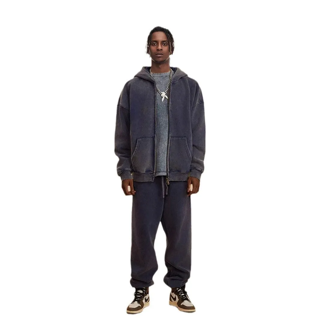 Man wearing a washed black cotton fleece-lined hooded cardigan with a double zipper front.