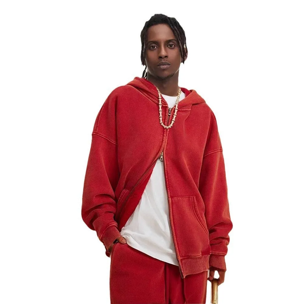 Man wearing a washed black cotton fleece-lined hooded cardigan with a double zipper front.