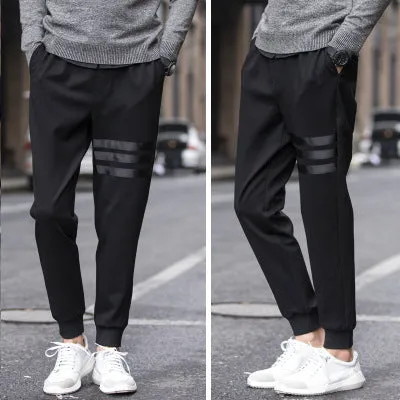 Men's casual slim sweatpants in black with elastic waistband and drawstring, side pockets, tapered leg, polyester fibre fabric