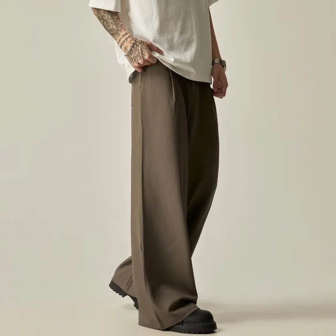 Men's solid black wide-leg casual trousers with a vertical tube design on a mid-waist.