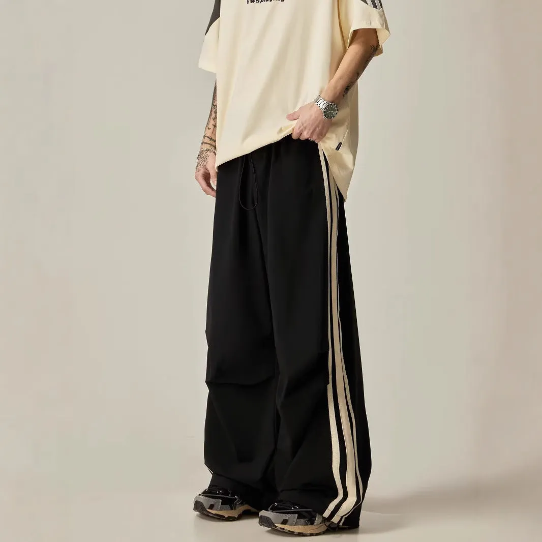 Black men's wide-leg high-waist climbing trousers laid flat, showing straight-leg cut.
