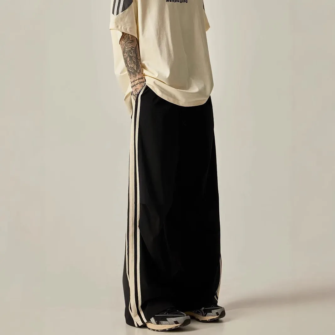 Black men's wide-leg high-waist climbing trousers laid flat, showing straight-leg cut.