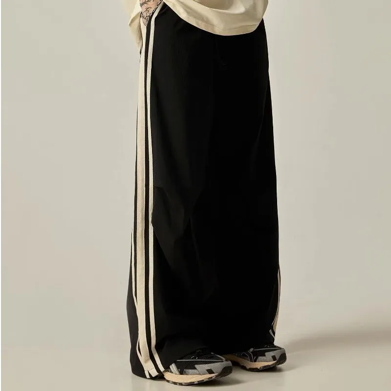Black men's wide-leg high-waist climbing trousers laid flat, showing straight-leg cut.