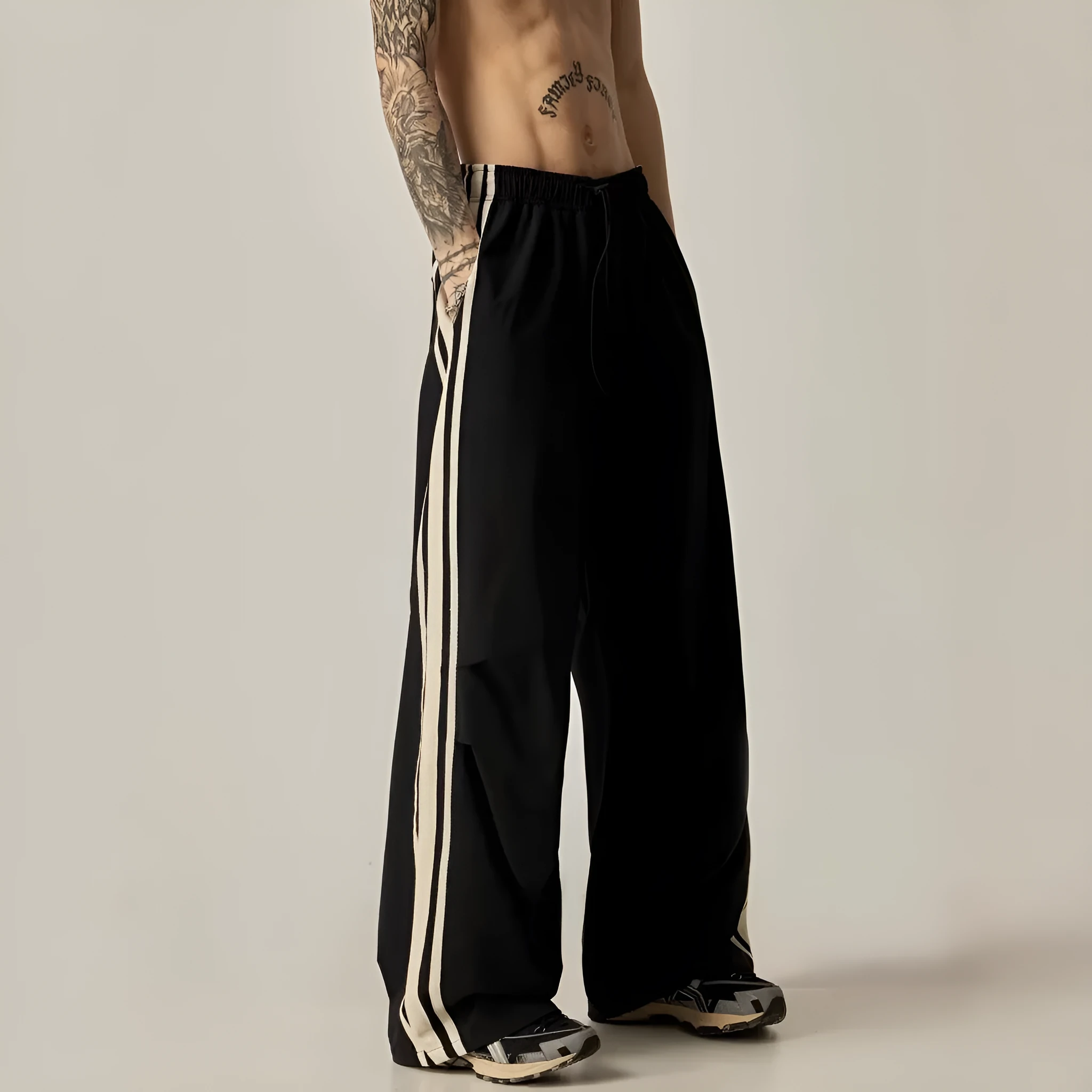 Black men's wide-leg high-waist climbing trousers laid flat, showing straight-leg cut.