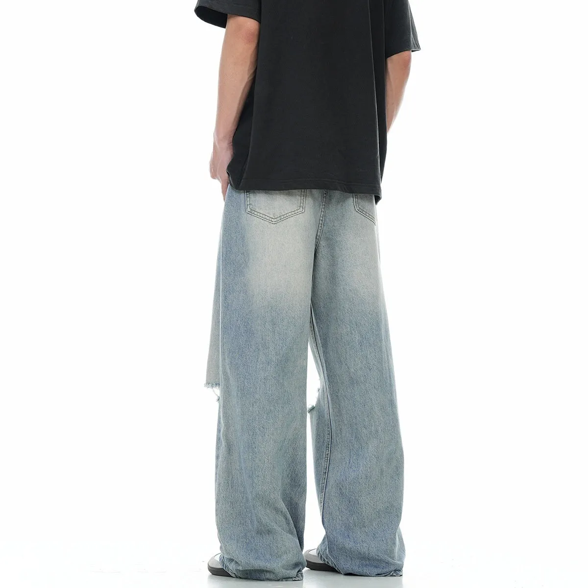 Blue retro straight-leg jeans with ripped details on a mannequin.